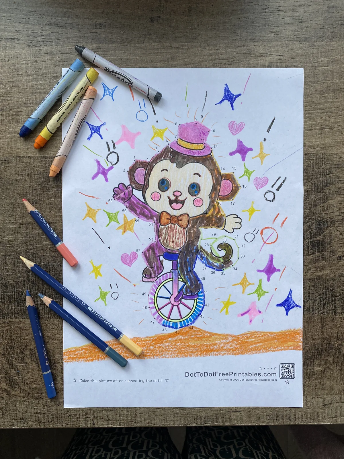 Finished circus monkey on a unicycle colored in purple, brown and orange Finished circus monkey on a unicycle colored in purple, brown and orange